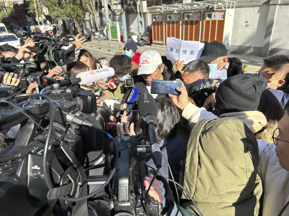 Jiang Hui, center, whose mother was on the missing MH370, speaks to journalists in Beijing Monday, Nov. 27, 2023. A Beijing court began compensation hearings Monday morning for Chinese relatives of people who died on a Malaysia Airlines plane that disappeared in 2014 on a flight to Beijing, a case that remains shrouded in mystery after almost a decade. (AP Photo/Ng Han Guan)