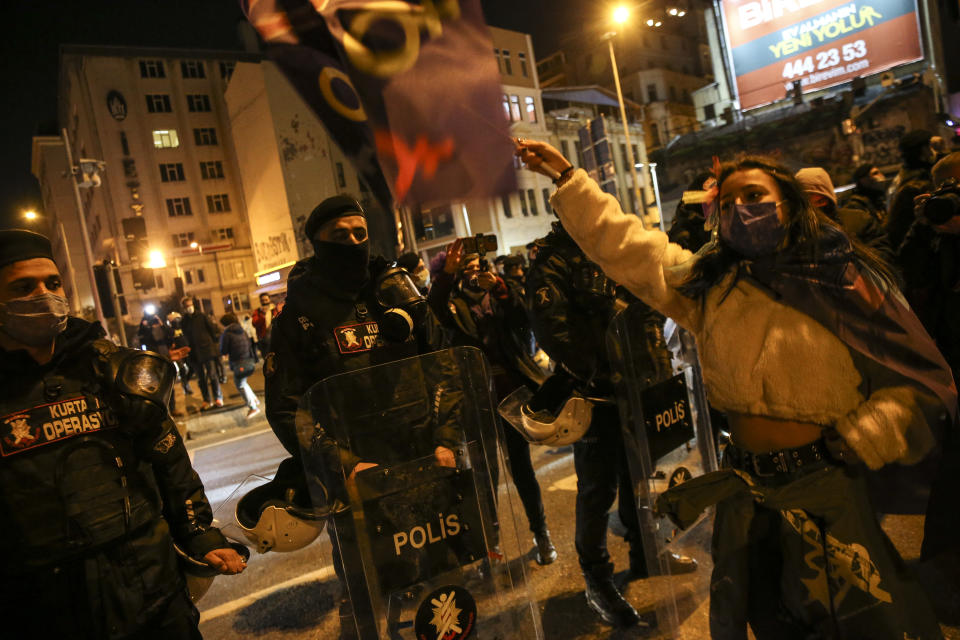 Protesters chant slogans in front of police officers during a rally to mark International Women's Day in Istanbul, Monday, March 8, 2021.Thousands of people joined the march to denounce violence against women in Turkey, where more than 400 women were killed last year. The demonstrators are demanding strong measures to stop attacks on women by former partners or family members as well as government commitment to a European treaty on combatting violence against women. (AP Photo/Emrah Gurel)