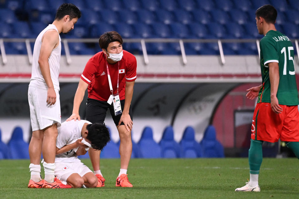 Japan's forward Takefusa Kubo cries after the defeat during the Tokyo 2020 Olympic Games men's bronze medal football match between Mexico and Japan at Saitama Stadium in Saitama on August 6, 2021.  / AFP / Jonathan NACKSTRAND