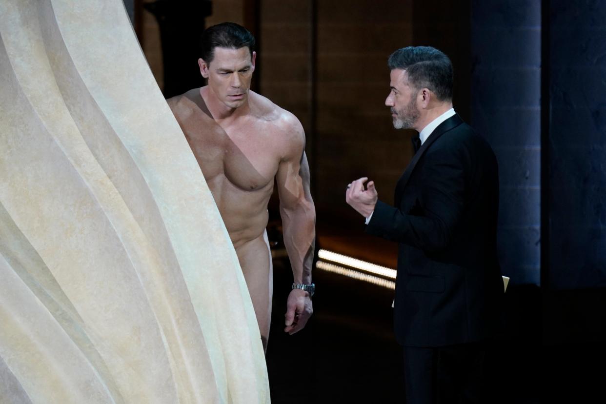 John Cena, left, presents the award for achievement in costume design along with Jimmy Kimmel during the 96th Oscars at the Dolby Theatre at Ovation Hollywood in Los Angeles on March 10, 2024.