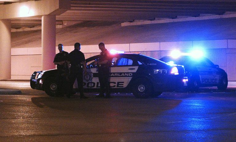 Police officers gather May 4, 2015 in Garland, Texas where two gunmen were shot dead outside a Prophet Mohammed cartoon contest
