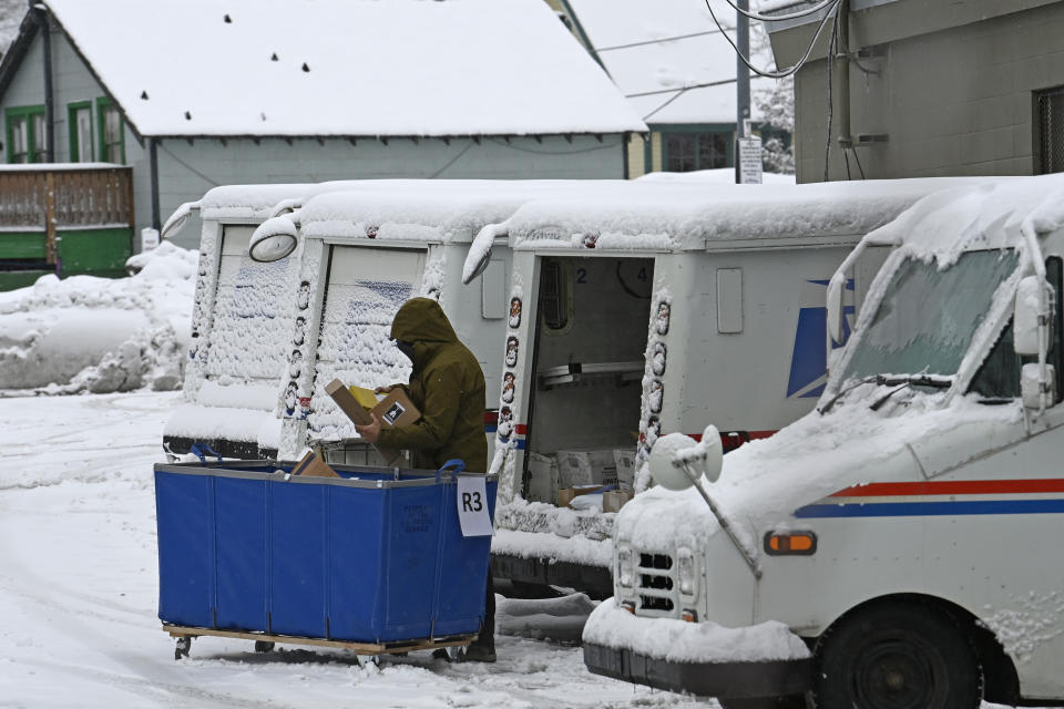 A mail carrier loads a mail truck with mail on Friday, March 1, 2024, in Lake Tahoe, Calif. The most powerful Pacific storm of the season is forecast to bring up to 10 feet of snow into the Sierra Nevada by the weekend (AP Photo/Andy Barron)