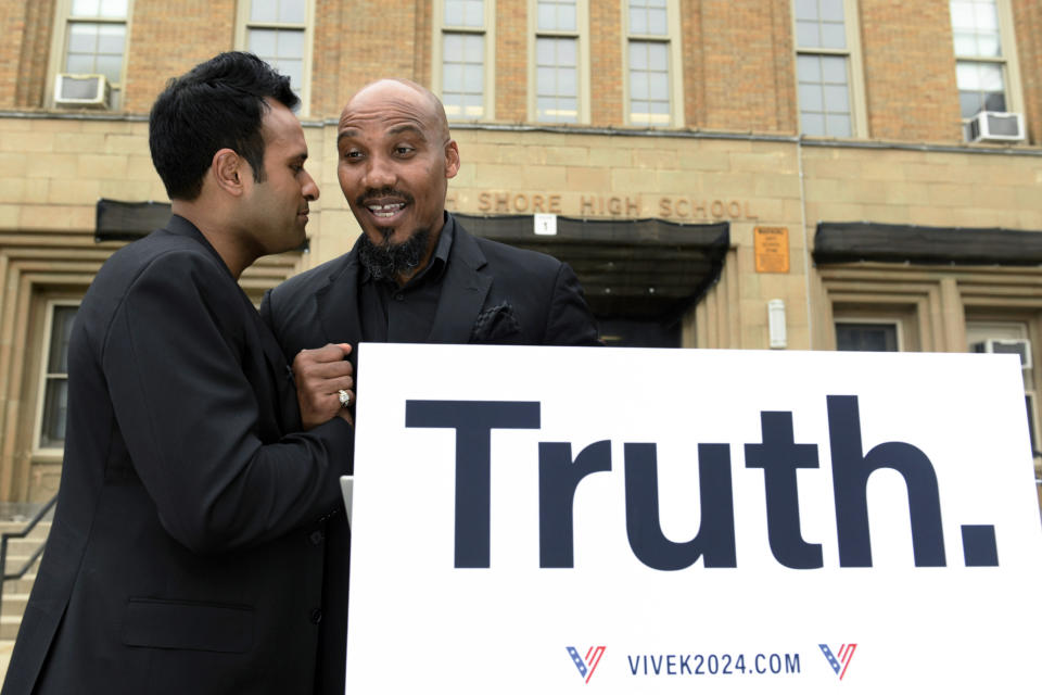 Republican Presidential candidate Vivek Ramaswamy left, speaks with ex inmate and author Tyrone Muhammad right, outside the shuddered former South Shore High School where the city of Chicago is planning to house illegal migrants Friday, May 19, 2023, in Chicago. (AP Photo/Paul Beaty)