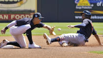 Detroit Tigers' Jonathan Schoop (7) steals second base ahead of the tag by New York Yankees shortstop Anthony Volpe during the first inning of a spring training baseball game Tuesday, March 21, 2023, in Tampa, Fla. (AP Photo/Chris O'Meara)