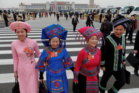 Delegates arrive to the third plenary session of the National People's Congress (NPC) at the Great Hall of the People to take a part in a vote on a constitutional amendment lifting presidential term limits, in Beijing, China March 11, 2018. REUTERS/Damir Sagolj