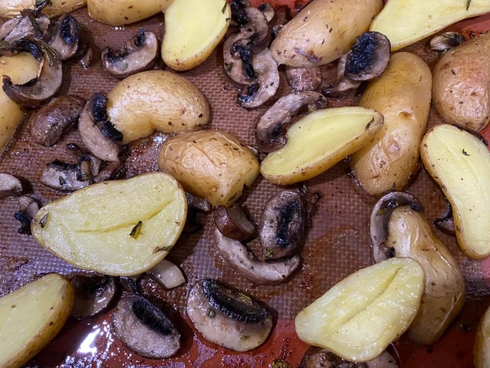 cooked mushrooms and potatoes on a sheet pan