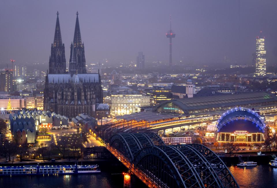 The illuminated city center with the Cathedral in Cologne, Germany, Tuesday, Nov. 29, 2022. An unprecedented crisis of confidence is shaking the Archdiocese of Cologne. Catholic believers have protested their deeply divisive bishop and are leaving in droves over allegations that he may have covered up clergy sexual abuse reports. (AP Photo/Michael Probst)