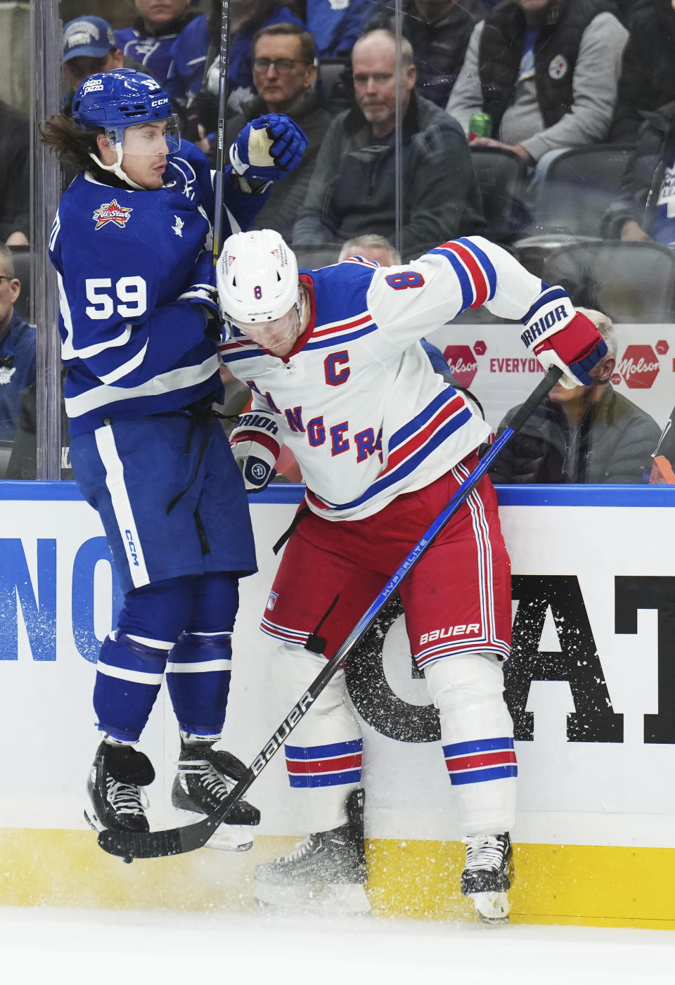 Toronto Maple Leafs forward Tyler Bertuzzi (59) collides with New York Rangers defenseman Jacob Trouba (8) during the second period of an NHL hockey game Tuesday, Dec. 19, 2023, in Toronto. (Nathan Denette/The Canadian Press via AP)