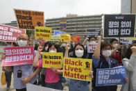 South Korean protesters shout slogans during a protest over the death of George Floyd, a black man who died after being restrained by Minneapolis police officers on May 25, near the U.S. embassy in Seoul, South Korea, Friday, June 5, 2020. The signs read "The U.S. government should stop oppression and there is no peace without justice." (AP Photo/Ahn Young-joon)