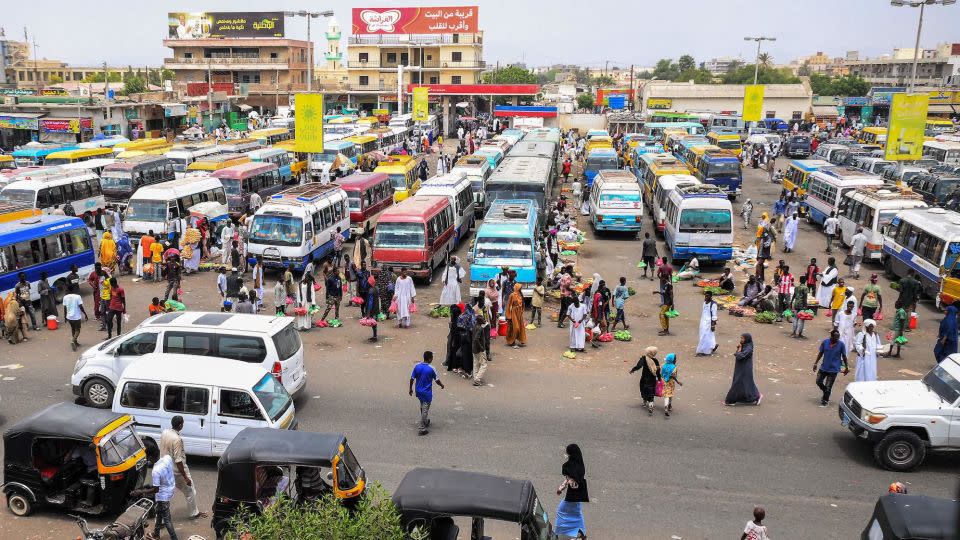 Vendors wait by minibuses and tuk-tuks for customers and passengers at a bus station in Port Sudan on May 23, 2023. The coastal city has become a hub for refugees trying to flee Sudan. - Stringer/AFP/Getty Images