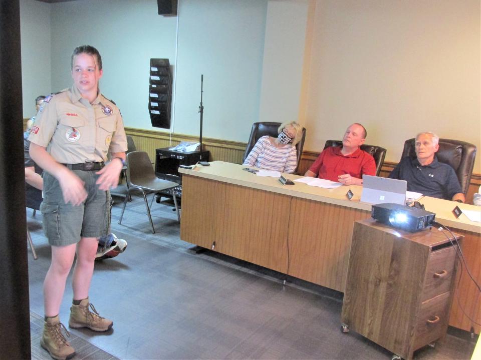 Millersburg council members Devone Polen (from left), Brent Hofstetter and Tom Vaughn look at the PowerPoint presentation in April by Life Scout Brenna Barbey about her proposed Eagle Scout project of building an amphitheater at Deer Run Park.