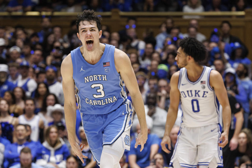North Carolina's Cormac Ryan (3) reacts ahead of Duke's Jared McCain (0) after hitting a three-point shot during the second half of an NCAA college basketball game in Durham, N.C., Saturday, March. 9, 2024. (AP Photo/Ben McKeown)
