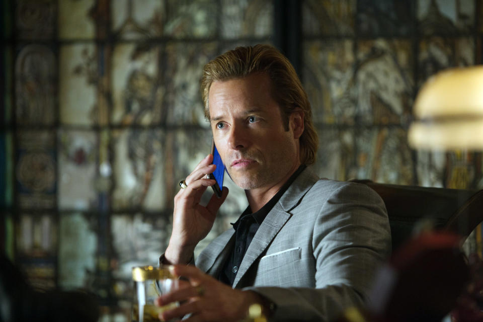 Aldrich Killian on his cell phone in an office
