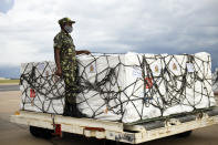 A Malawian policeman guards AstraZeneca COVID-19 vaccines after the shipment arrived at the Kamuzu International Airport in Lilongwe, Malawi, Friday March 5, 2021. The country is the latest in Africa to receive vaccines in a fight against COVID-19. (AP Photo/Thoko Chikondi)