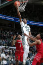 Michigan State's Marcus Bingham Jr. (30) goes up for a layup against Louisville's Noah Locke, right, and Malik Williams (5) during the first half of an NCAA college basketball game Wednesday, Dec. 1, 2021, in East Lansing, Mich. (AP Photo/Al Goldis)