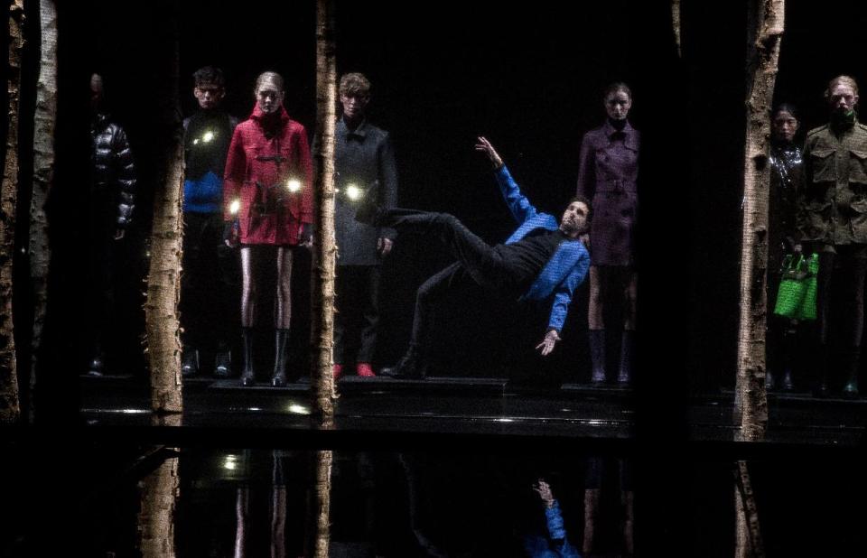 British magician Dynamo, centre, performs a rick following the show by Hunter Original during London Fashion Week Autumn/Winter 2014, at Ambika Gallery in central London, Saturday, Feb. 15, 2014. (Photo by Joel Ryan/Invision/AP)