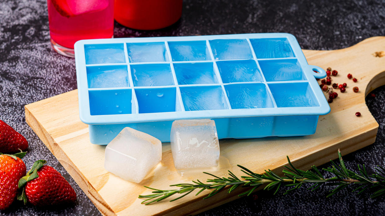  An ice cube tray on a chopping board 