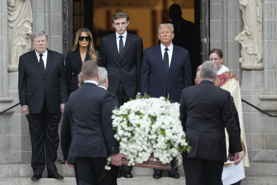 Former President Donald Trump, center right, stands with his wife Melania, second left, their son Barron, center left, and father-in-law Viktor Knavs, as the coffin carrying the remains of Amalija Knavs, the former first lady's mother, is carried into the Church of Bethesda-by-the-Sea for her funeral, in Palm Beach, Fla., Thursday, Jan. 18, 2024. (AP Photo/Rebecca Blackwell)