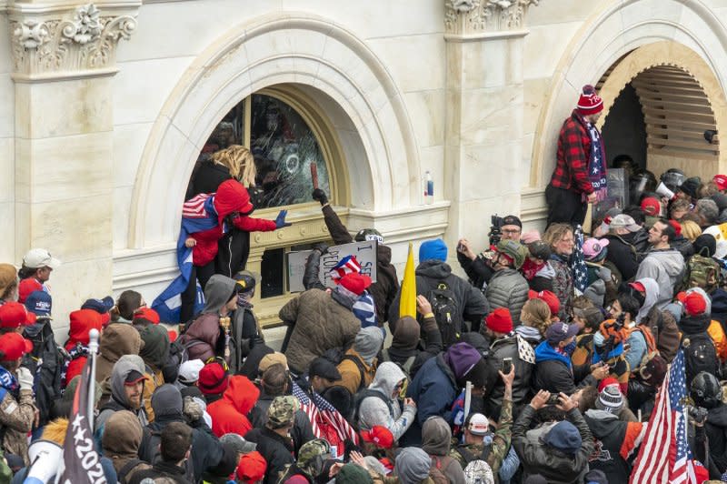 Pro-Trump rioters breach the security perimeter and penetrate the U.S. Capitol to protest against the Electoral College vote count that would certify President-elect Joe Biden as the winner in Washington, D.C., on January 6, 2021. File Photo by Ken Cedeno/UPI