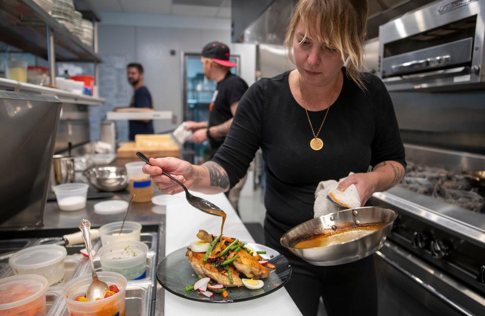 Chef Abbi Merriss uses double reduced chicken stock to finish off a dish at Kan-Kan Cinema and Brasserie in 2021. Her work at Bluebeard landed her a semifinalist spot for the James Beard awards' best chef in the Great Lakes region for a sixth time in 2023.