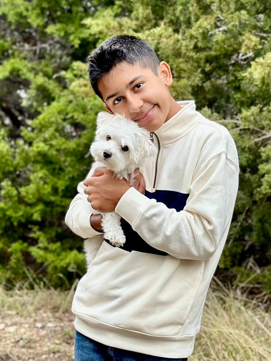 Jaron Rodriguez, shown with his dog Chloe, is now 10 years past his cancer diagnosis, and he is an ambassador for St. Baldrick's Foundation to raise money for childhood cancer research.