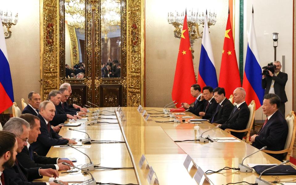 Members of the Chinese delegation meet their Russian counterparts at the Kremlin for talks. - EPN/Newscom / Avalon