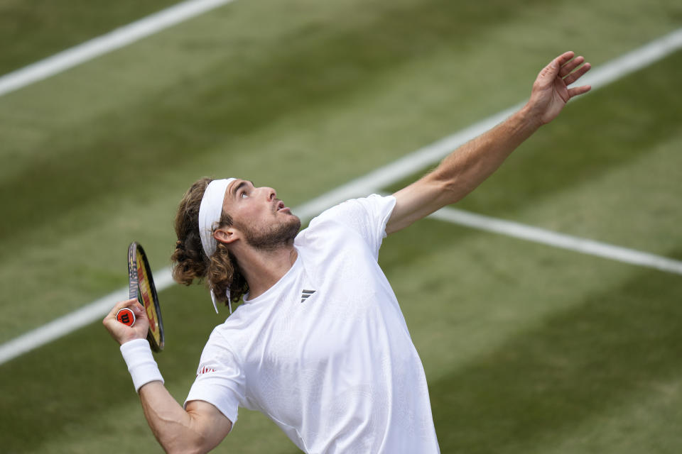 Stefanos Tsitsipas of Greece serves to Christopher Eubanks of the US in a men's singles match on day eight of the Wimbledon tennis championships in London, Monday, July 10, 2023. (AP Photo/Alastair Grant)