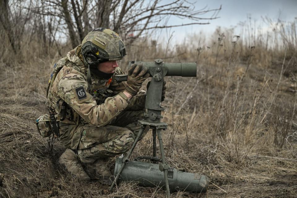 A Ukrainian serviceman aims at Russian positions near the city of Bakhmut yesterday (AFP via Getty Images)