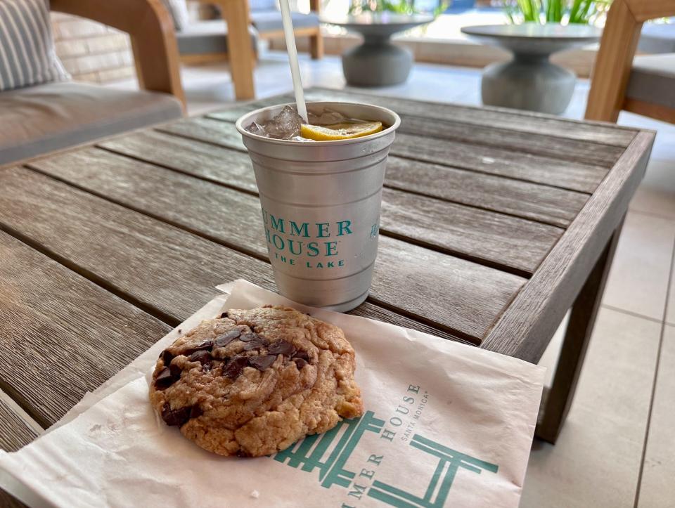 a cookie and a drink on a table on the patio at summer house in disney springs