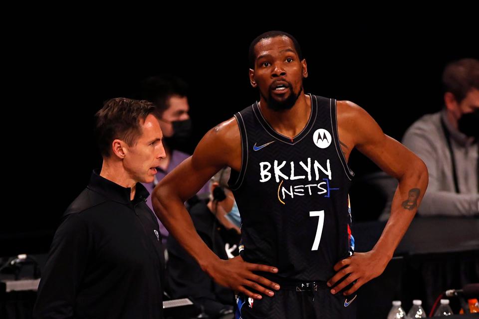 Brooklyn Nets forward Kevin Durant (7) talks with head coach Steve Nash during a break in play against the Boston Celtics in the first half of Game 5 during an NBA basketball first-round playoff series, Tuesday, June 1, 2021, in New York. (AP Photo/Adam Hunger)