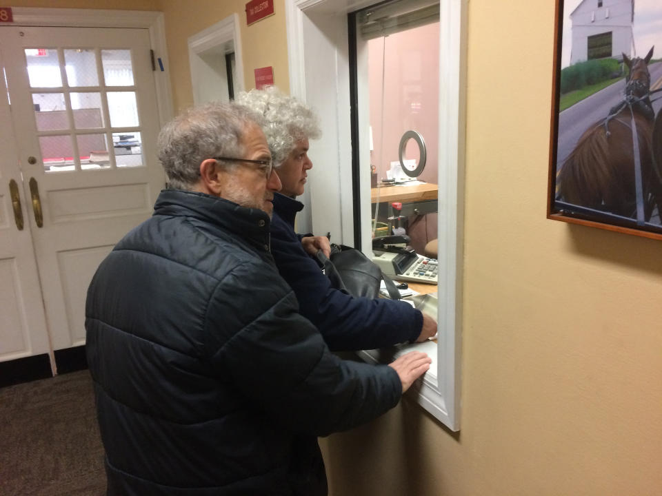 Gail Trachtenberg and Lewis Eron prepay part of their 2018 property tax bill at the township building in Cherry Hill, New Jersey, on Thursday, Dec. 22, 2017. People across the country have been trying to prepay property taxes before a federal tax overhaul kicks in and caps deductions for state and local taxes. (AP Photo/Geoff Mulvihill)