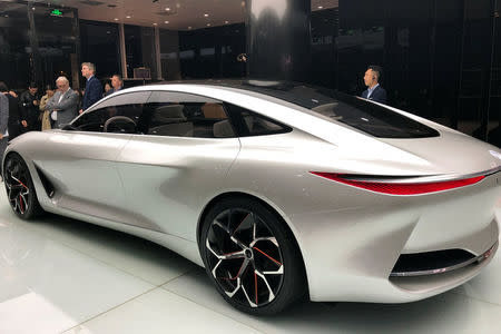 People gather around Infiniti's Q Inspiration concept car at an event in Beijing, China April 23, 2018. REUTERS/Joe White