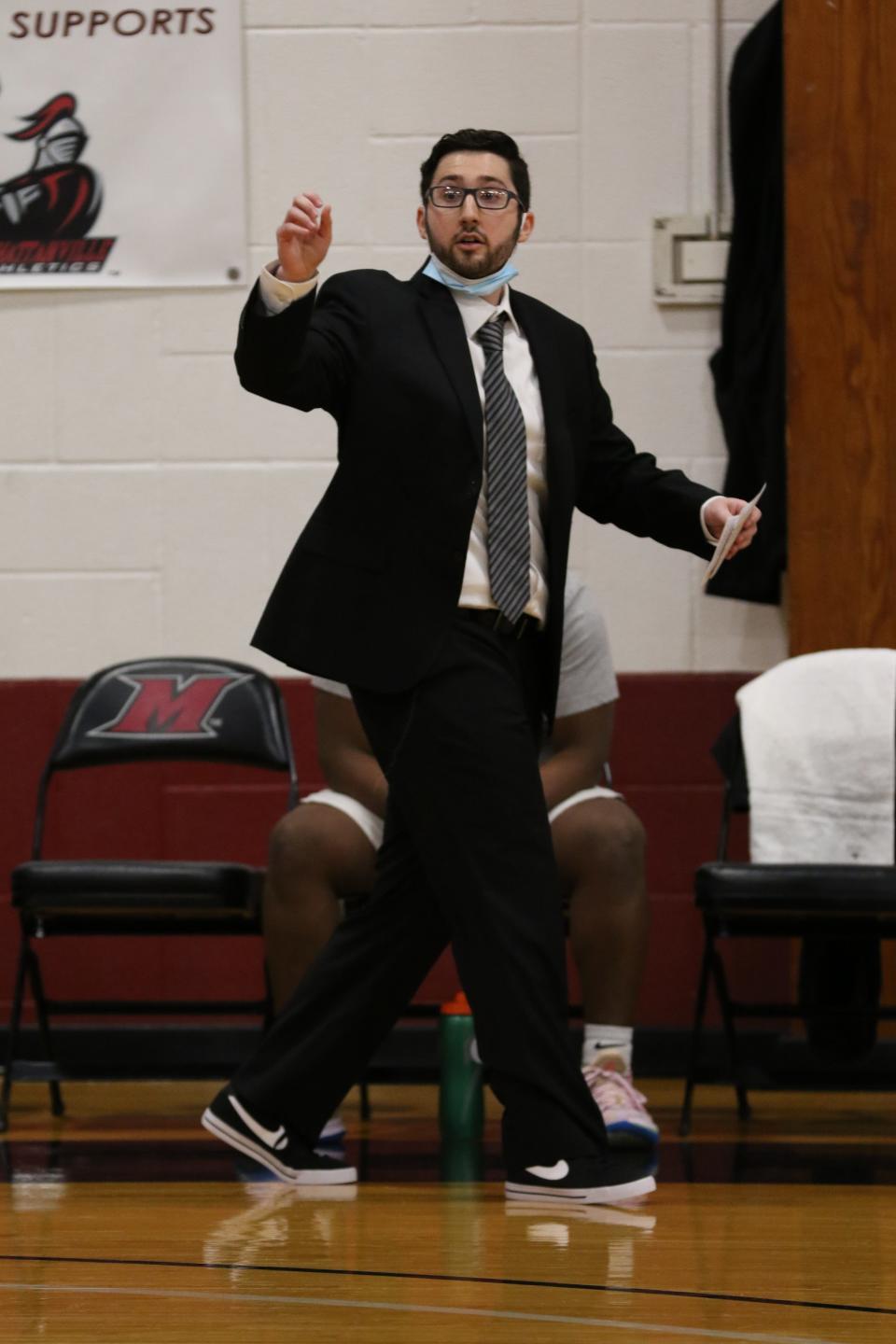 Sean McGee calls out instructions to his Mahanttanville College men's basketball team during a Jan. 12, 2022 game against USMMA. The 23-year-old assistant made his head coaching debut, filling in for Chris Alesi.