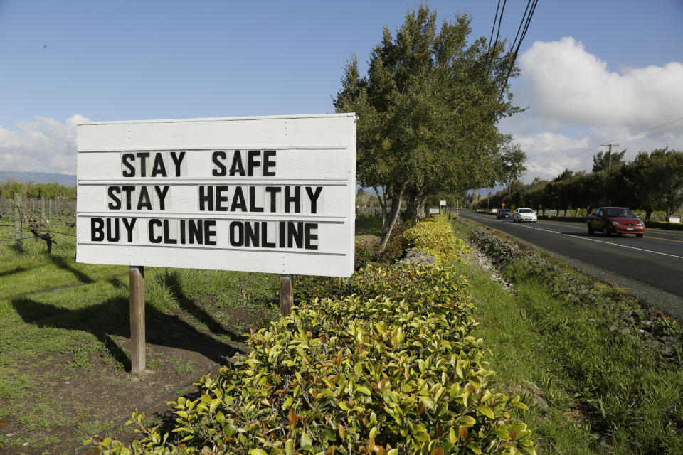 A sign outside the Cline Cellars winery urges motorists on Highway 121 to be safe and buy online Thursday, March 19, 2020, in Sonoma, Calif. The winery is closed because of the coronavirus threat. As worries about the spread of the coronavirus confine millions of Californians to their homes, concern is growing about those who have no homes in which to shelter.(AP Photo/Eric Risberg)