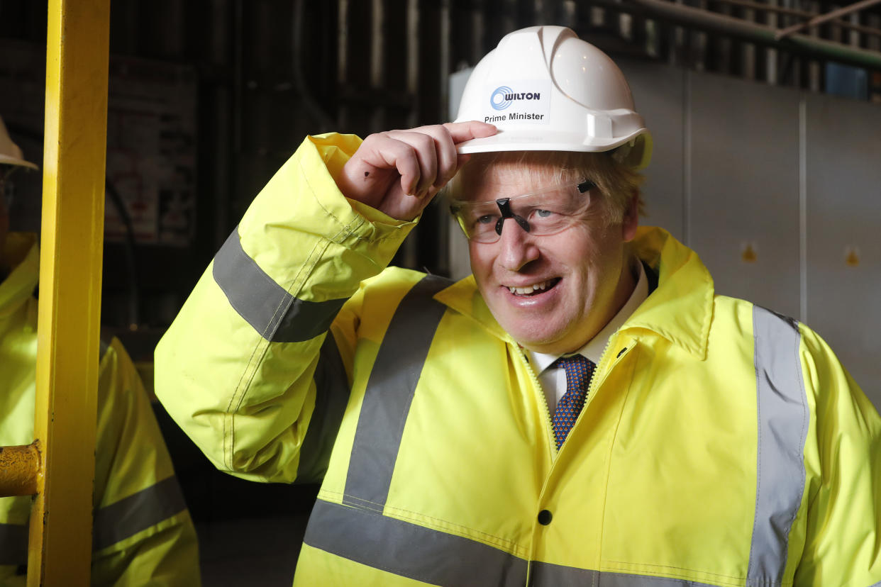 Britain's Prime Minister Boris Johnson wears a construction helmet reading "Prime Minister" during a visit to Wilton Engineering Services, part of a General Election campaign trail stop in Middlesbrough, England, Wednesday, Nov. 20, 2019. Britain goes to the polls on Dec. 12. (AP Photo/Frank Augstein, Pool)