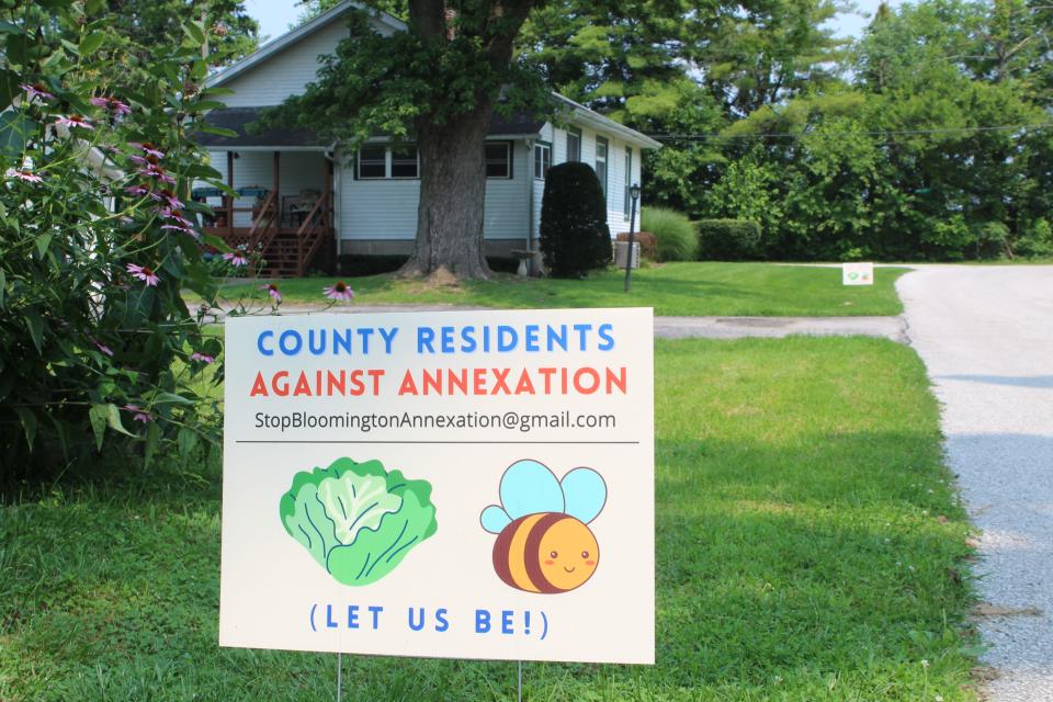 One of the "Let us be!" signs designed by Susan Brackney is seen in her front yard in July.