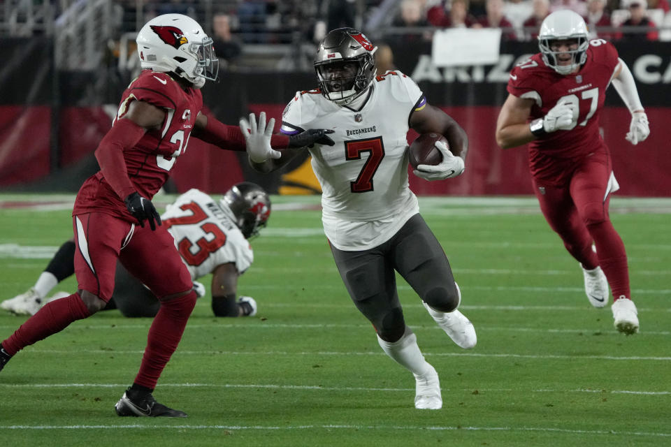 Tampa Bay Buccaneers running back Leonard Fournette (7) runs as Arizona Cardinals safety Jalen Thompson pursues during the first half of an NFL football game, Sunday, Dec. 25, 2022, in Glendale, Ariz. (AP Photo/Rick Scuteri)