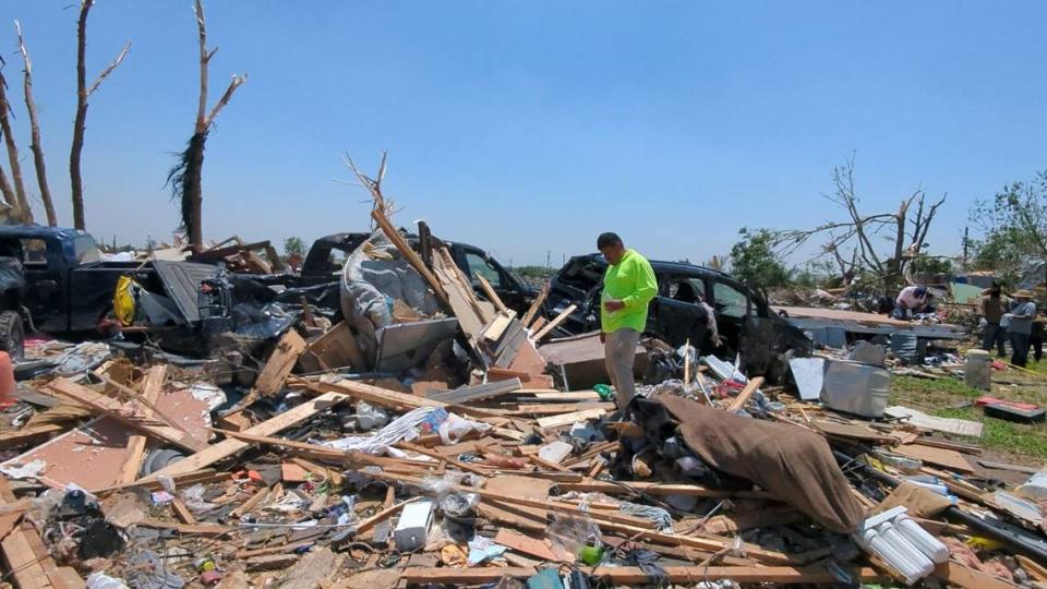 Jose Narano stands in the wreckage on Sunday, May 26, 2024, where his neighbors were killed when a tornado hit their Valley View, Texas neighborhood.