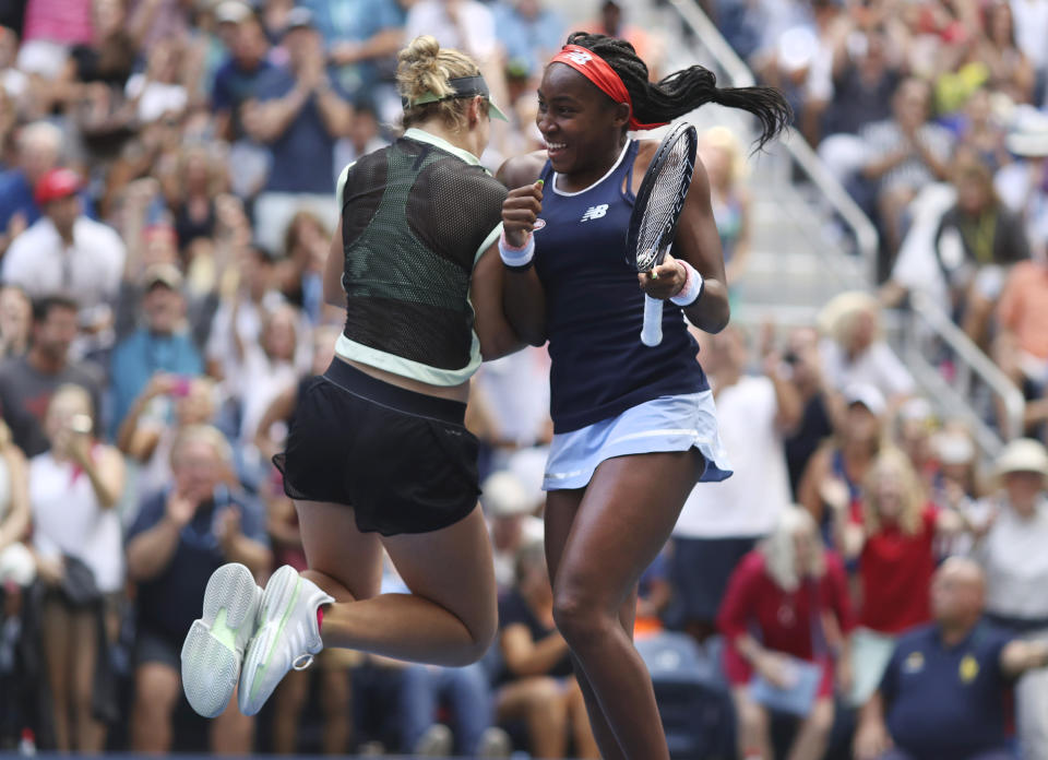 Coco Gauff, right, and her partner Catherine McNally celebrate after winning their women's doubles second round match, against Nicole Melichar and Kveta Peschjka, at the US Open tennis championships Sunday, Sept. 1, 2019, in New York. (AP Photo/Kevin Hagen)
