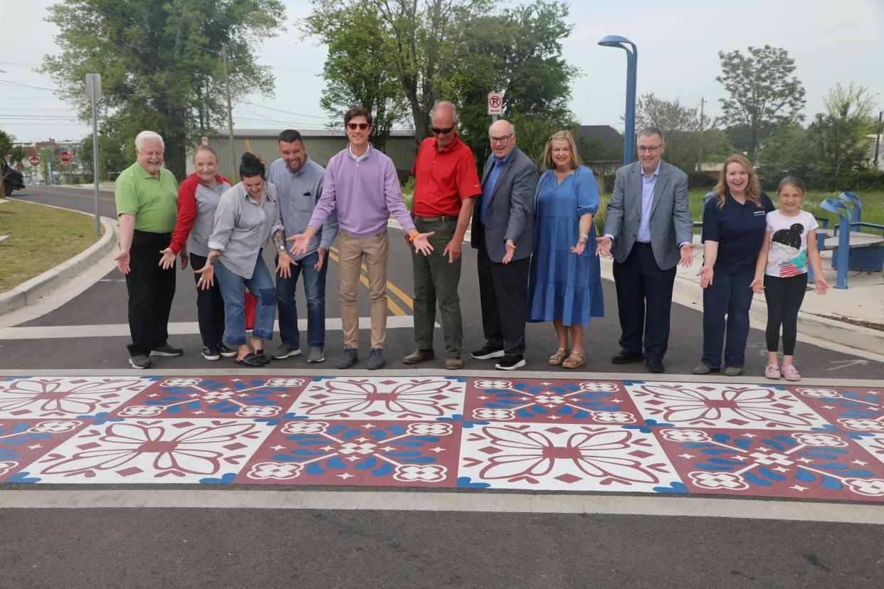 City leaders and artist Whitney Herrington, third from left, unveil Columbia's first artistic crosswalk at South Garden and Depot Streets, an area of the city's Arts District which recently completed a streetscape project to upgrade the roadway and create space for art.