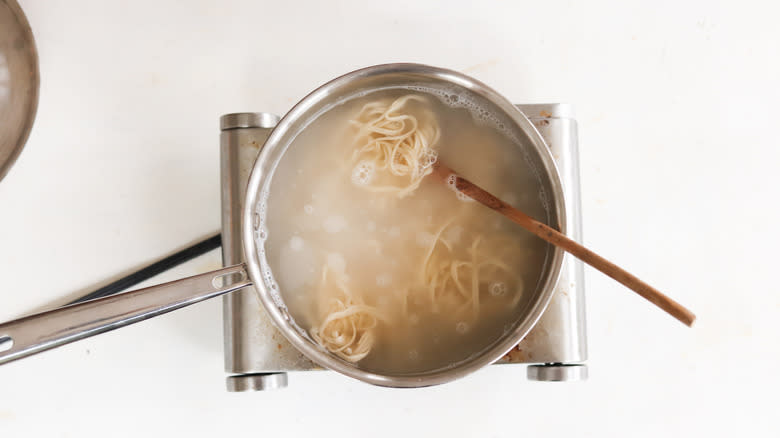 ramen noodles boiled in a pot of water