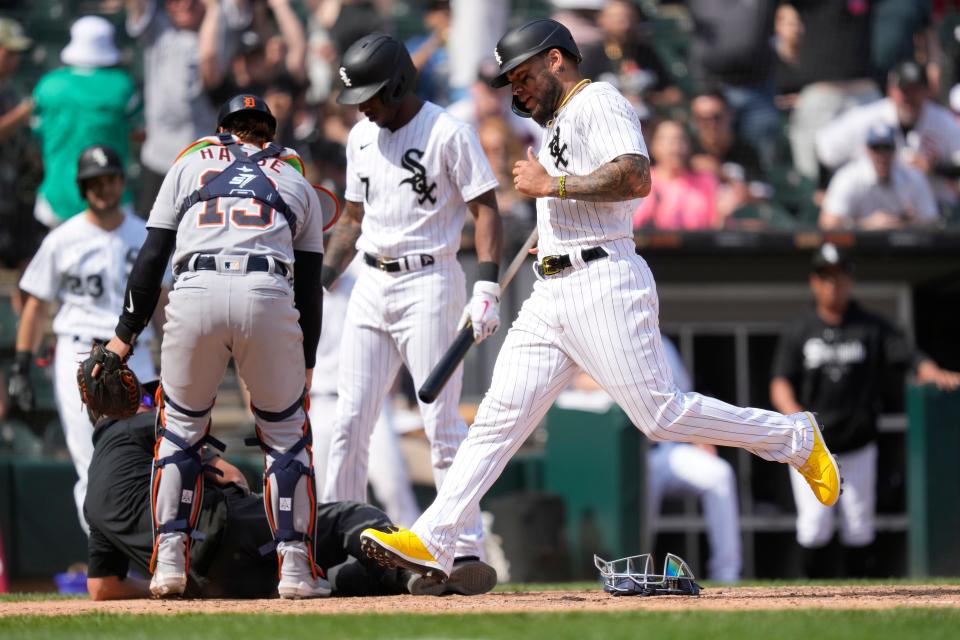 Chicago White Sox's Yoan Moncada scores the game winning run on Detroit Tigers relief pitcher Jose Cisnero's wild pitch in the 10th inning at Guaranteed Rate Field in Chicago on Saturday, June 3, 2023. Tigers catcher Eric Haase and Tim Anderson look after home plate umpire Cory Blaser who was knocked down on the play. The White Sox won 2-1.