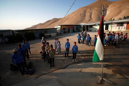 Palestinian students participate in a morning exercise at their school in Jordan Valley in the Israeli-occupied West Bank