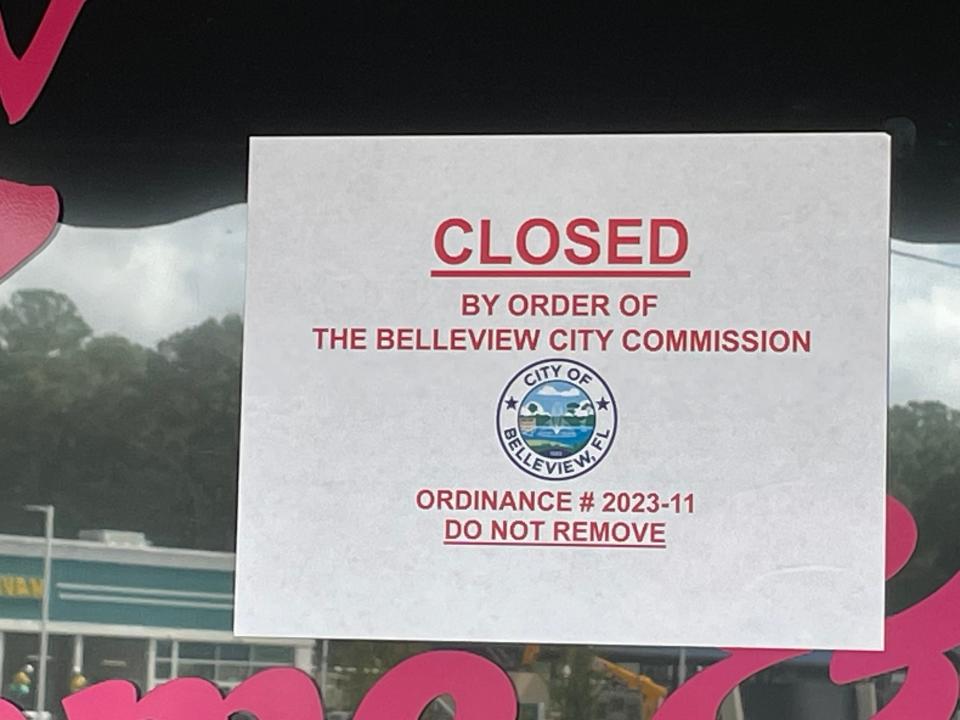 Closed sign placed on the door of an internet café by city officials
