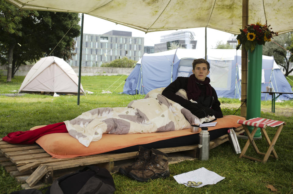 Climate activist Henning Jeschke, who is since 24 days on a hunger strike, lays on a mattress under a tent in a small camp of climate activists as he poses for a photo in Berlin, Wednesday, Sept. 22, 2021. With his hunger strike he hopes to pressure candidates for chancellor of Germany into meeting him for a debate about the climate crisis ahead Sunday's general election. For the first time in Germany's history, climate change is a central issue of an election campaign, overwhelmingly so for the young generation. (AP Photo/Markus Schreiber)