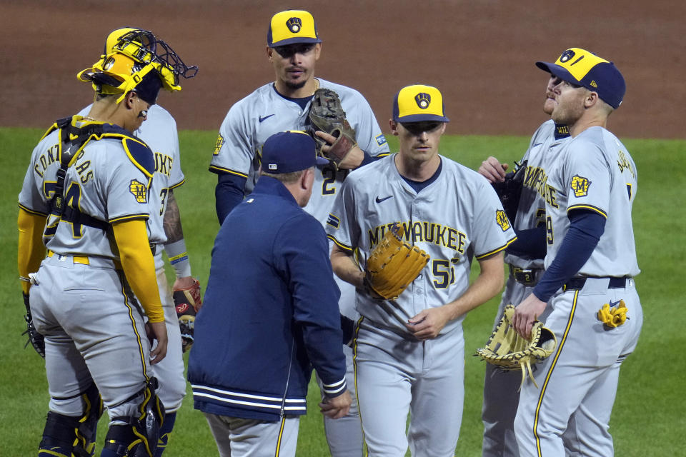 Milwaukee Brewers pitcher Hoby Milner (55) walks to the dugout after handing the ball to manager Pat Murphy during the sixth inning of the team's baseball game against the Pittsburgh Pirates in Pittsburgh, Monday, April 22, 2024. (AP Photo/Gene J. Puskar)