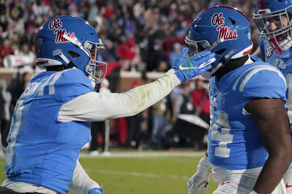 Mississippi wide receiver Jahcour Pearson (0) gives running back Snoop Conner (24) a tap after Conner scored a 13-yard touchdown during the second half of an NCAA college football game against Texas A&M, Saturday, Nov. 13, 2021, in Oxford, Miss. Mississippi won 29-19. (AP Photo/Rogelio V. Solis)