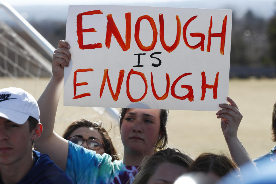 FILE - In this March 14, 2018 file photo, fifteen-year-old Leah Zundel waves a placard during a student walkout to protest gun violence on the soccer field behind Columbine High School in Littleton, Colo. Most of the students who commit deadly school attacks were bullied, had a history of disciplinary trouble and their behavior concerned others, but it wasn’t reported. That’s according to a comprehensive study by the U.S. Secret Service’s National Threat Assessment Center of 41 school attacks since the 1999 Columbine High School Shooting. (AP Phoot/David Zalubowski)