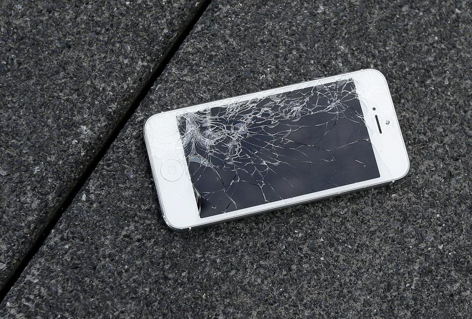 This Aug. 26, 2015 photo shows an Apple iPhone with a cracked screen after a drop test from the DropBot, a robot used to measure the sustainability of a phone to dropping, at the offices of SquareTrade in San Francisco.