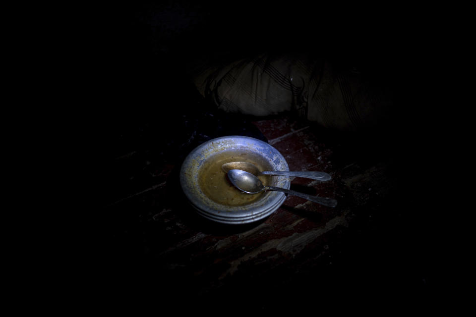 Spoons rest in a bowl as it sits on the floor in a holding cell in the basement of a police station which was used by Russian forces in the recently retaken town of Izium, Ukraine, Thursday, Sept. 22, 2022. Based on accounts of survivors and police, Associated Press journalists located 10 torture sites in the town and gained access to five of them. This clammy underground jail was one of them. It reeked of urine and rotting food. (AP Photo/Evgeniy Maloletka)